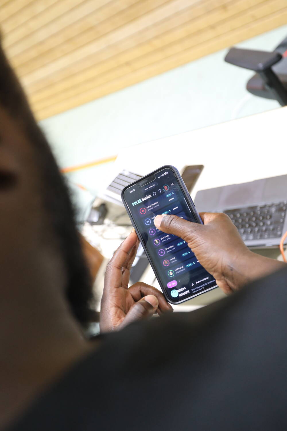 Live highlights feed on a player's phone Smartphone in a player's hand showing the live highlights feed with clips from the ongoing matchday